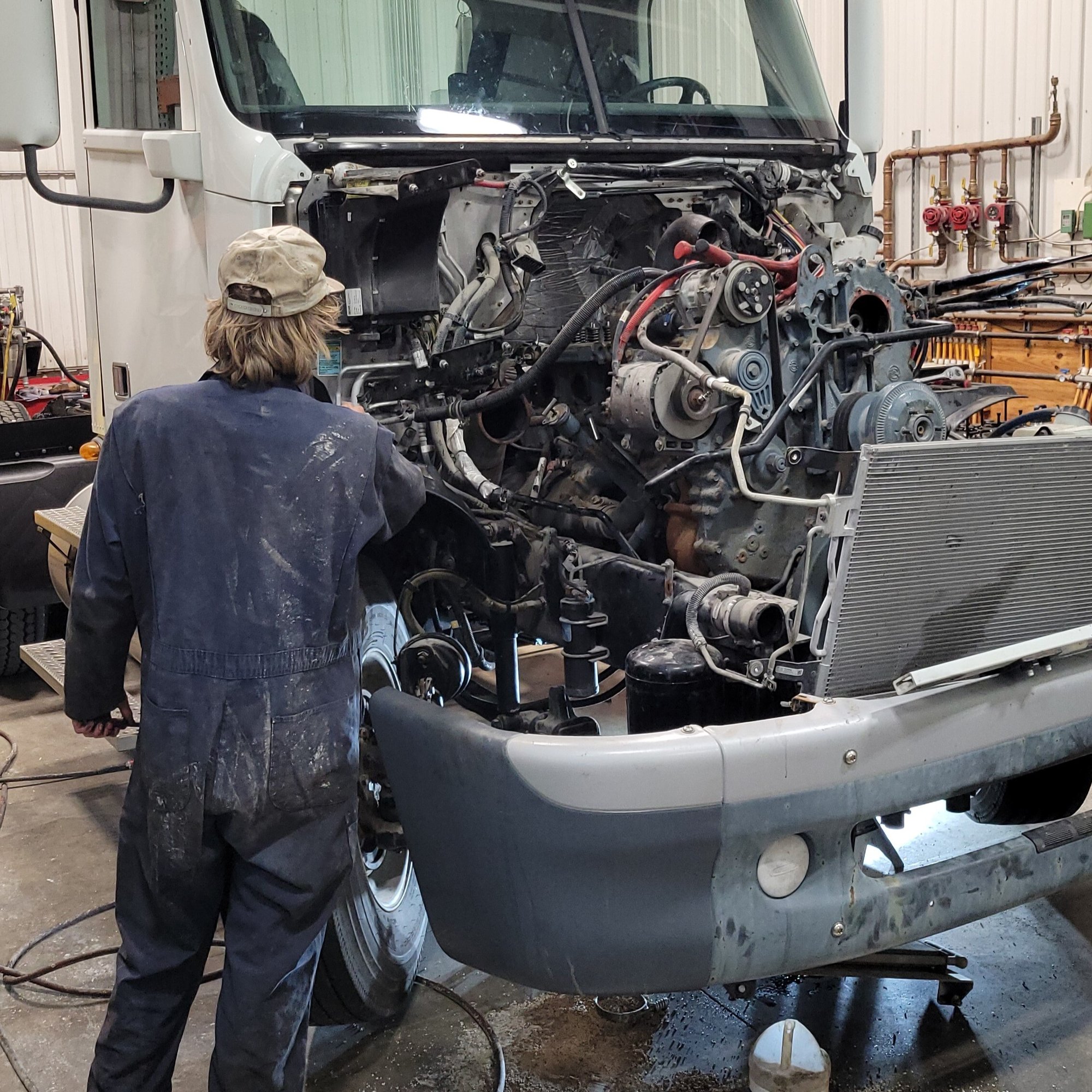 Mechanic looking at engine Mechanic looking at engine